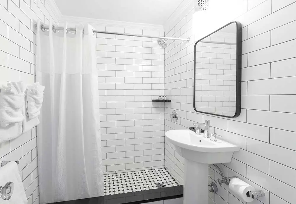 White titled bathroom with shower and sink