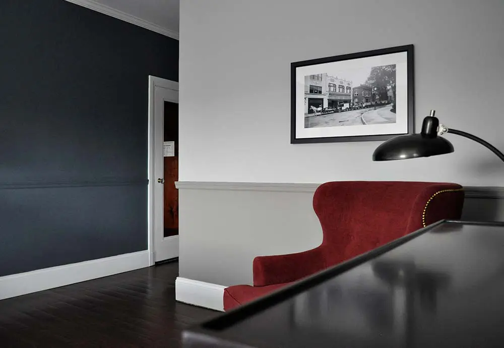 hotel room with lamp and red chair