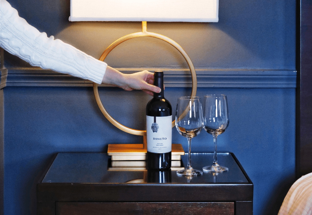 Wine Bottle and 2 Glasses in Hotel Room